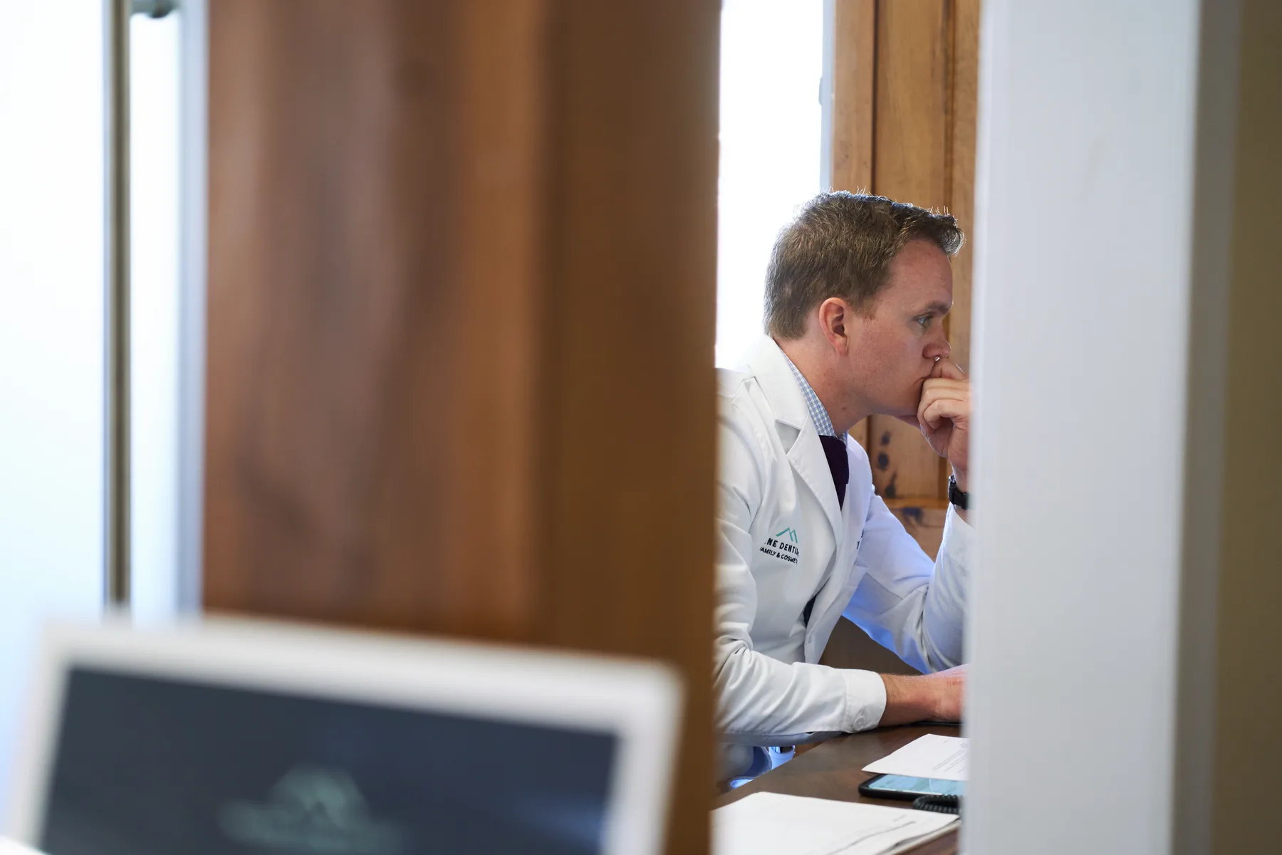 Dr. Lawlor sitting thoughtfully at a desk