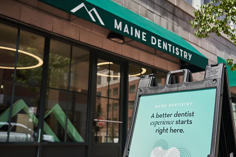 Maine Dentistry Portland office exterior with its green awning and welcome sign